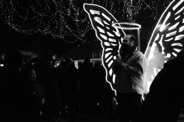 Syntagma square, Athens.Man posing as angel on a Christmas bazzar.