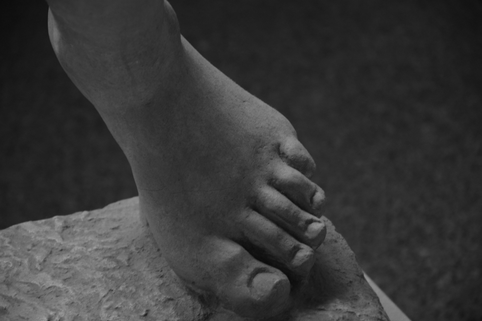 Ancient Greece, detail of a male figure statue, foot, Archeological museum of Athens.