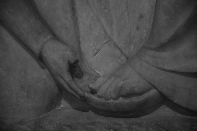 Ancient Greece, detail of a statue, hand touching foot. Archeological museum of Athens.
